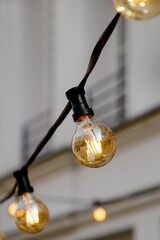 Glowing light bulbs on a wire on a wall background