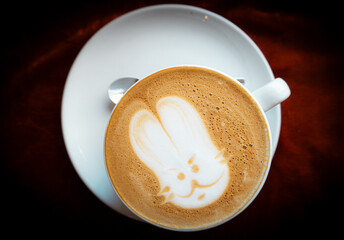 Bunny in the foam of delicious coffee. Cute Rabbit Latte Art in a White Coffee Cup. Adorable Rabbit...