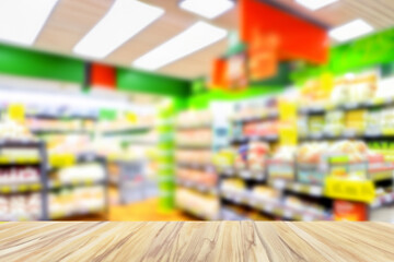 Wood table top with supermarket grocery store blurred defocused background with bokeh light for product display