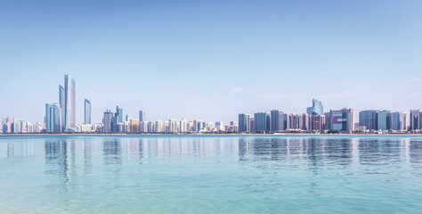 Abu Dhabi Skyline with skyscrapers with water - obrazy, fototapety, plakaty