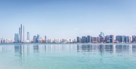 Gordijnen Abu Dhabi Skyline with skyscrapers with water © Mariakray