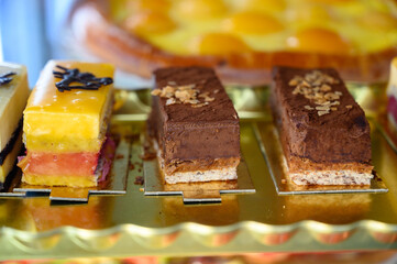 French fresh baked sweet pastry with chocolate, fresh fruits and berries in confectionery shop close up