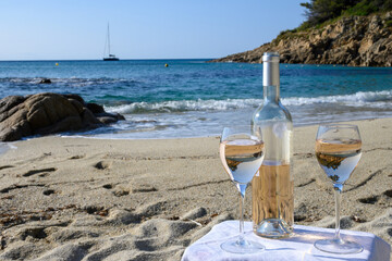 Summer time in Provence, two glasses of cold rose wine on Pampelonne sandy beach near Saint-Tropez in sunny day, Var, France