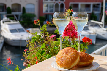 Celebration with champagne sparkling wine and french stuffed with apples or chocolate beignets donuts pastry, sweet dessert served outdoor
