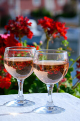Pouring in glasses of cold rose Cote de Provence wine in yacht harbour of Port Grimaud, summer vacation on French Riviera Provence, France