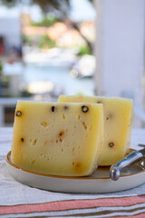 Cheese collection, Italian aged pecorino cheese with black peppers made in region Nebrodi, Sicily, Italy, close up