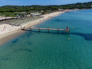 Crystal clear blue water of legendary Pampelonne beach near Saint-Tropez, summer vacation on white sandy beach of French Riviera, France