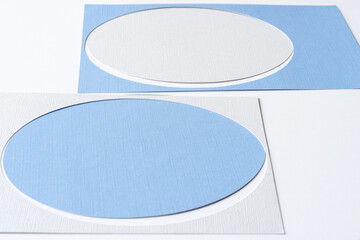 blue and gray white ovals and stencil frames on blank paper