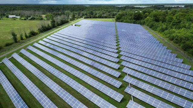 Aerial Drone Shot of Solar Panel Renewable Energy Farm on Sunny Summer Day in Country Field Rural Canada Ontario