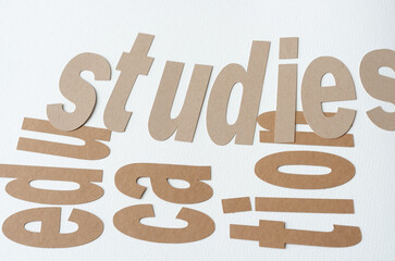 machine-cut paper sign with the words "studies" and "education"                                               d