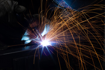welder, mig or tig welding, craftsman, erecting technical steel Industrial, pretty sparks from weld pistol, steel welder in factory technical