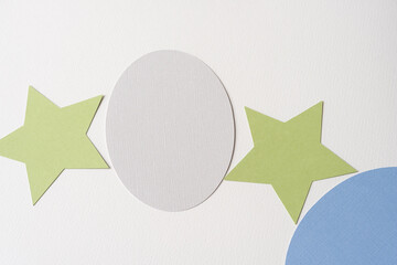 machine-cut ovals and green stars on blank paper