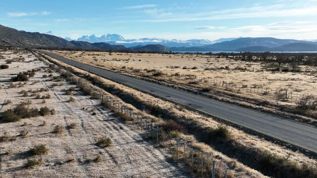 Rural Road At Puerto Natales In Ultima Esperanza Chile. Snowy Mountains. Road Landscape. Ultima Esperanza Chile. Winter Background. Rural Road At Puerto Natales In Ultima Esperanza Chile.