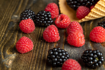 Ripe red raspberries in a crispy waffle cone