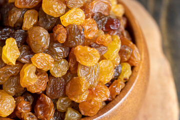 Dried yellow golden raisins on a board