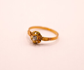 gold ring with a diamond in the middle 