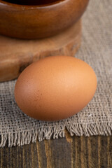 A whole orange chicken egg close-up on the table