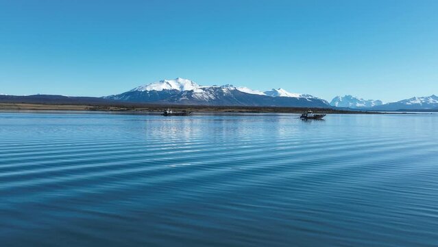 Boat Sailing At Puerto Natales In Ultima Esperanza Chile. Snowy Mountains. Bay Water Landscape. Ultima Esperanza Chile. River Background. Boat Sailing At Puerto Natales In Ultima Esperanza Chile.