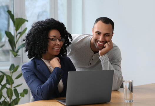 Young colleagues working together at table in office