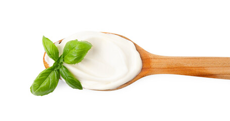 Wooden spoon with tasty mayonnaise and basil isolated on white, top view