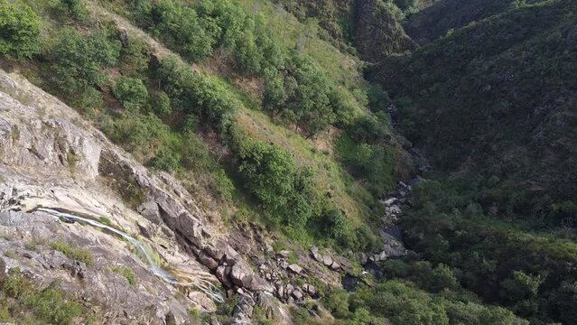 Aerial view over "Frecha da Mizarela" waterfall - the largest waterfall on the Iberian Peninsula. Serra da Freita, Portugal 2023.