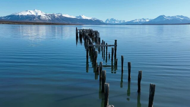 Famous Port At Puerto Natales In Ultima Esperanza Chile. Snowy Mountains. Bay Water Landscape. Ultima Esperanza Chile. River Background. Famous Port At Puerto Natales In Ultima Esperanza Chile.