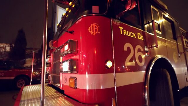 Fisheye footage of the front of a fire truck with flashing lights at night in the snow
