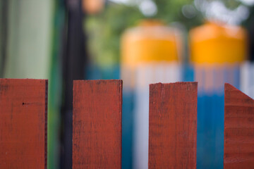 Multi Colored Wooden Fence with blur background in the garden. copy space. selective focus	