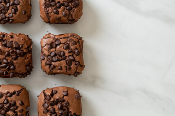 dark chocolate brownies topped by chocolate chips