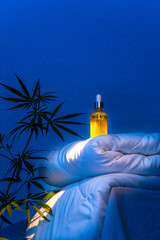 CBD oil tincture, marijuana branch on blanket podium in moonlight to improve quality