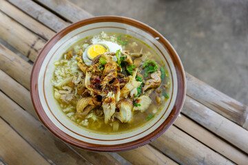 Indonesian chicken soup mainly composed with rice, chicken, and egg. Soto ayam Lamongan.