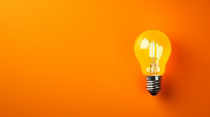 LED filament light bulb with copy space on orange background