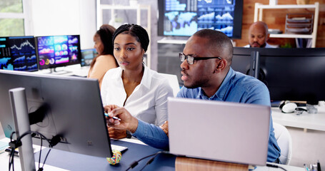 African Financial Data Analysts Using Dashboard On Screens