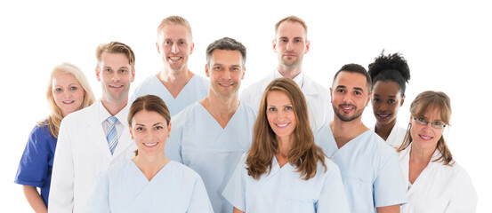 Happy Medical Team Standing Against White Background