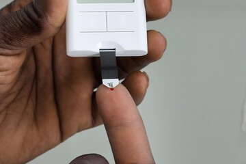 Patient Hands With Glucometer