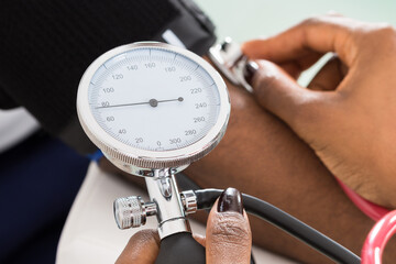 Doctor Measuring Patients Blood Pressure