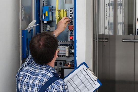 Technician Repairing Elevator