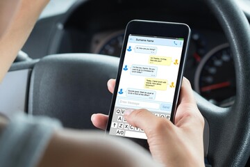 Close-up Of Woman Typing Text Message On Mobile Phone