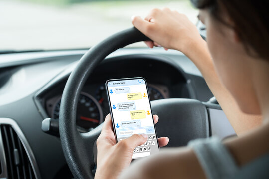 Close-up Of Woman Typing Text Message On Mobile Phone