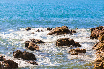 Fototapeta na wymiar blue sea with rocks on the coast