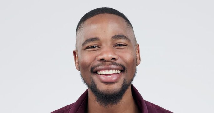 Happy, face and a black man on a white background, laughing and showing confidence. Smile, young and portrait of an African person or model looking cheerful with an expression on a studio backdrop