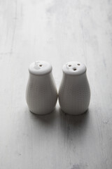 Salt and peppers white shakers