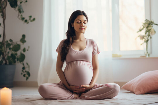 Pregnant Indian woman doing meditation or breathing exercises for healthy pregnancy.