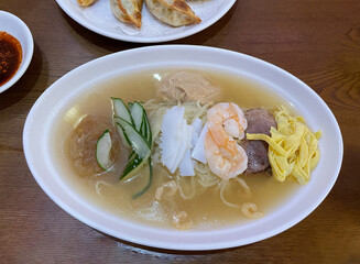 Chinese cold noodles in a white bowl, close-up