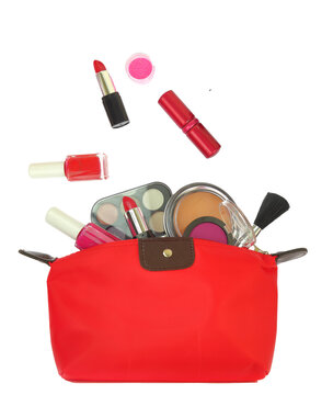 Cosmetics makeup products out of a red purse isolated on white transparent background, PNG. 