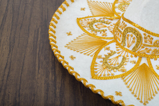 Mexican charro hat on wooden table. Mariachi hat. Typical mexican sombrero.