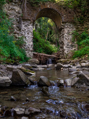 Picturesque ruins of the narrow-gauge viaduct carriage bridge in the village of Vorokhta,...