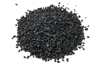 Pile of natural activated carbon scattered isolated on white background. activated carbon is used for effective applications in adsorption, removal of pollutants, water treatment, and energy, etc.