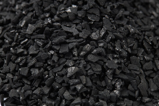 Top view of activated carbon scattered isolated on white background. activated carbon is used for effective application in adsorption, removal of pollutants and water treatment etc. texture background