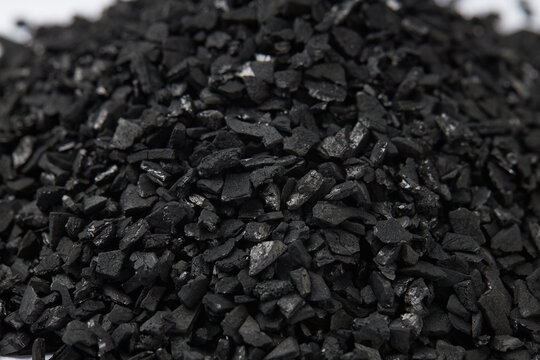Top view of activated carbon scattered isolated on white background. activated carbon is used for effective application in adsorption, removal of pollutants and water treatment etc. texture background